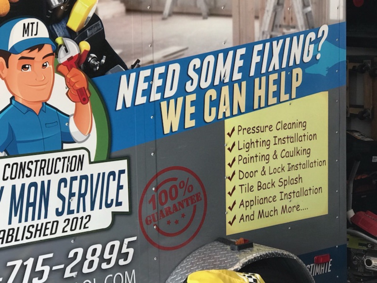 MTJ Construction trailer close-up with services checklist